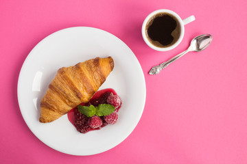 Wall Mural - Continental breakfast with croissant, coffee  and raspberry jam on the pink background. Top view. Copy space.