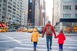© travnikovstudio - Family of father and little kids on Times Square during their vacation in New York City