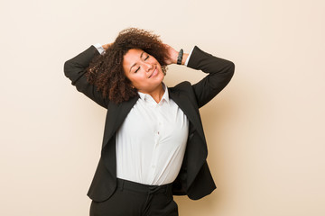 Wall Mural - Young business african american woman stretching arms, relaxed position.