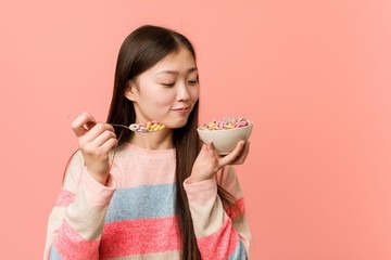 Young asian woman holding a cereal bowl