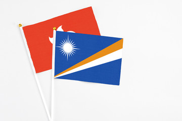 Poster - Marshall Islands and Hong Kong stick flags on white background. High quality fabric, miniature national flag. Peaceful global concept.White floor for copy space.