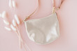 © Deidre - Modern shiny leather purse on pink background
