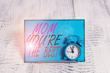 Conceptual Hand Writing Showing Mom You Re The Best. Concept Meaning Appreciation For Your Mother Love Feelings Compliment Alarm Clock Tilted Above Buffer Wire In Front Of Notepaper