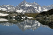 Mountains reflected in mirror like surface of a lake near Riffelsee, Switzerland