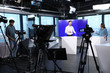 © New Africa - Presenters and video camera operator working in studio. News broadcasting