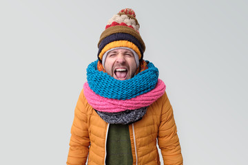 Sticker - Young man in winter hat and scarf shouting