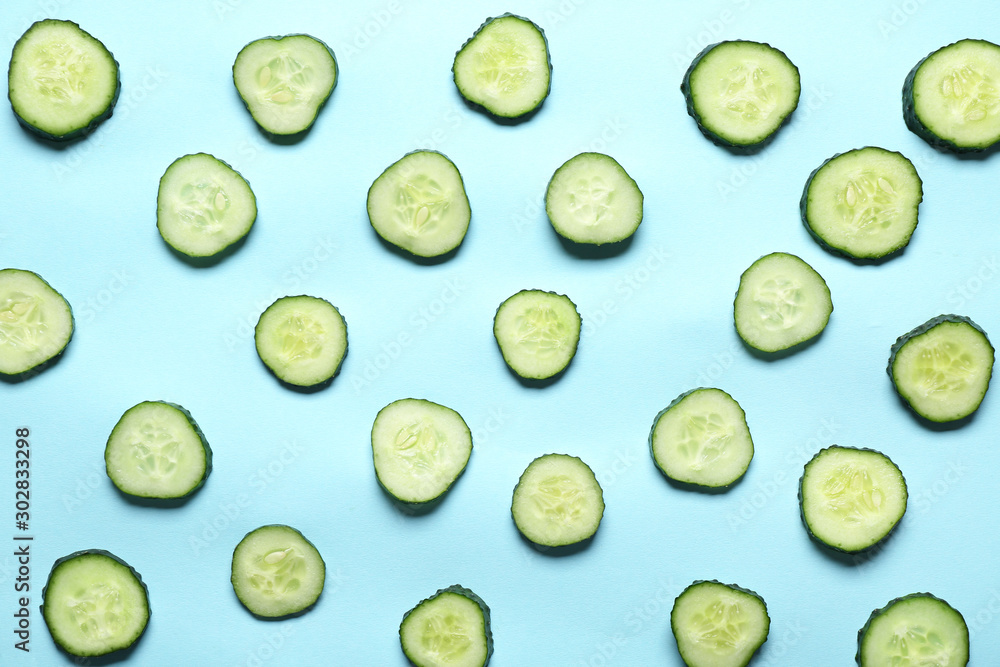 Pieces of fresh cucumbers on color background