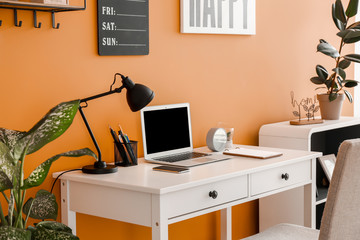 Wall Mural - Stylish workplace with laptop near color wall