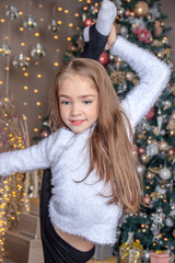 Little cute girl near the Christmas tree . New year and Christmas. Christmas tree decoration.