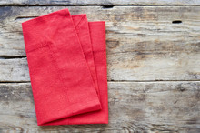Red Linen Napkin On A Wooden Background