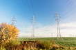 © Hanna - Electric transmission lines with electricity on a field in the morning in autumn