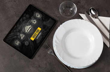 Online fast food order concept on a laid table