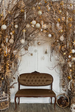 Christmas Decorations With Natural Details: Branches With Garland Lights And Christmas Balls And A Classic Sofa. Eco Decor In Interior Concept. Creative Christmas Tree.