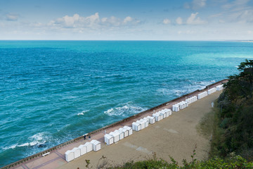 Poster - many white beach huts on the boardwalk in Granville on the Normandy coast