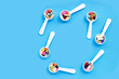 © Bowonpat - Colorful medicine pills, tablets and capsules on blue background.