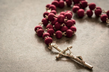 Wall Mural - Catholic rosary on the stone background