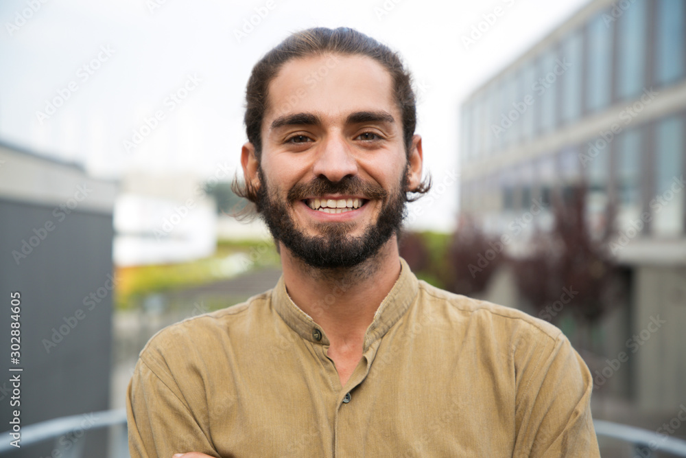 Handsome happy bearded man. Portrait of cheerful young man standing outdoors and smiling at camera. Emotion concept - obrazy, fototapety, plakaty 