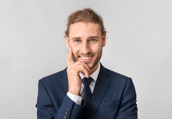 Canvas Print - Portrait of businessman on grey background