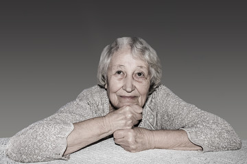 Wall Mural - Senior grey haired woman dreaming isolated on blue background