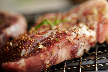 Steak meat with herb and spice on grill 