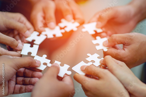 Fotomural Team work, hands and jig Saw Unite with power Is a good team of successful peopl