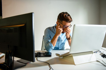 Wall Mural - Young man sitting in his office	