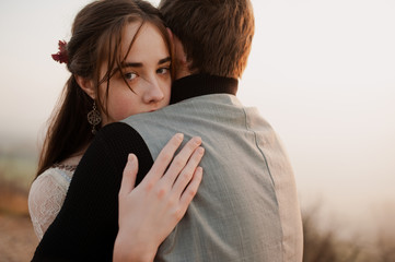 farewell hugs of a guy and a girl. evening. frame from the movie. book cover