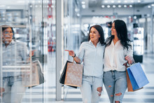 Two Young Women Have A Shopping Day Together In The Supermarket