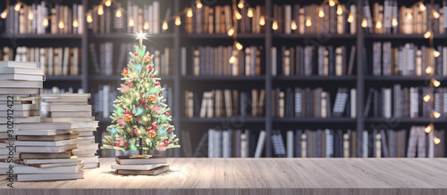 Photographie Decorated Christmas tree on Bookshelf in the library with old books, Holidays in