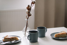 Piece Of Apple Pie On Plate With Cup Of Coffee On White Table. Breakfast With Coffee And Cake In Cafe. Food Photography. 