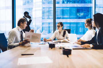 Wall Mural - Coworking modern business people discussing papers in office