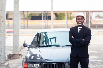 Wall Mural - African man construction engineer worker standing with the car