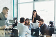 © BullRun - Confident male and female business owners discussing trade accounting and management strategy for company, young group of people in formal wear collaborating together during teamwork in office