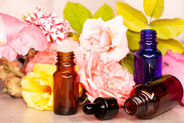 rose flowers and bottles of essential oils for aromatherapy