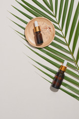 Wall Mural - spa concept with, massage salt in spoon and bottles of essential oil with small leave