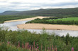 © Thomas - View on the beautiful Kemijoki river with sandbanks with a traditonal boat, beautiful forest and grass surroundings and little green mountains, Kemi, Finland, Europe