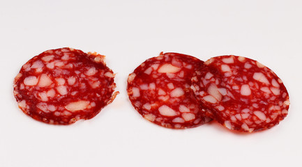 Poster - Red sausage sliced on a white background