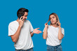 © ianachyrva - Blond woman and brunet man in white tees and blue jeans are talking on the phone.