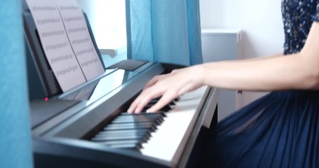 Poster - Teenage girl playing piano at home, closeup