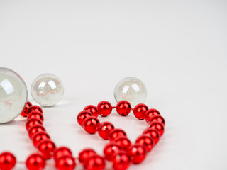 Sticker - red beads transparent ball lie on a white background