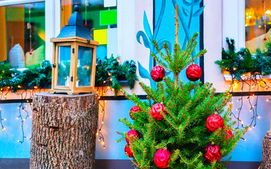 Wall Mural - Christmas tree and Street lantern on Christmas Market in Riga Old Town in winter. Street Xmas and holiday fair. Advent Decoration and Stalls with Crafts on Bazaar