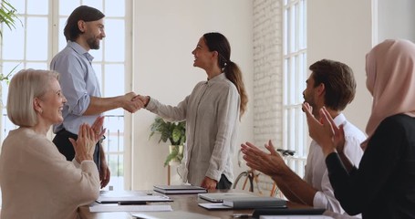Wall Mural - proud company manager shake hand praise happy female employee