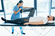 © Peakstock - man treat lumbar disc. man lying on massage table while his physical therapist doing special exercises for physical therapy for sciatica and pinched nerve problems