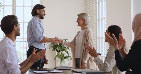 Poster - Happy older female employee get promoted rewarded handshaking boss