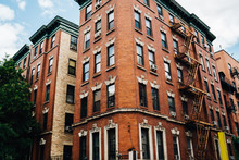 Tall Vintage Building With Expensive Apartment For Rent Located In Brooklyn District, Red Stone Urban Architecture Construction Exterior With Windows For Residence Housing On Old Historical Street .