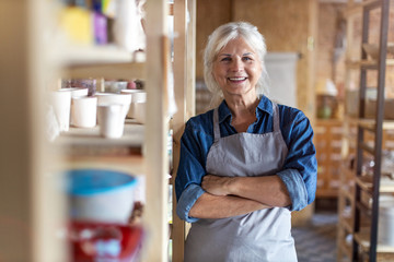 Wall Mural - Portrait of senior female pottery artist in her art studio