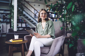 Attractive young student with tablet in library