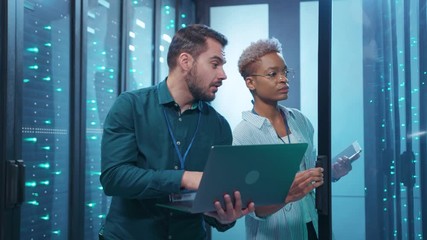 Wall Mural - african woman engineer and server technician coworking upgrading hardware system in server rack cabi