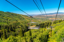 Off Season At Park City Ski Resort With Chairlifts Over Mountain And Greenery