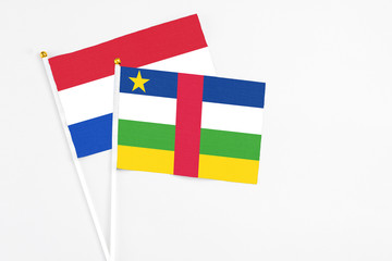 Central African Republic and Paraguay stick flags on white background. High quality fabric, miniature national flag. Peaceful global concept.White floor for copy space.